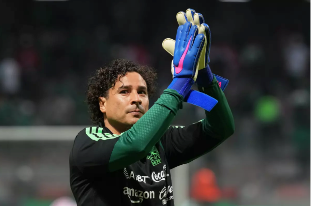 Guillermo Ochoa recibe la bandera de México previo al arranque del Mundial de Futbol